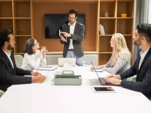 A team of professionals engaged in a digital signage consulting session, discussing strategies and solutions for effective content deployment and engagement.