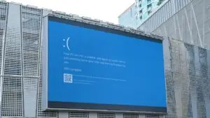 Large outdoor digital billboard displaying a Windows blue screen error, highlighting potential technical issues in free digital signage networks