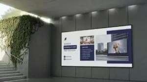 Outdoor digital signage display advertising expert consulting services mounted on concrete wall with green vine elements and stairway